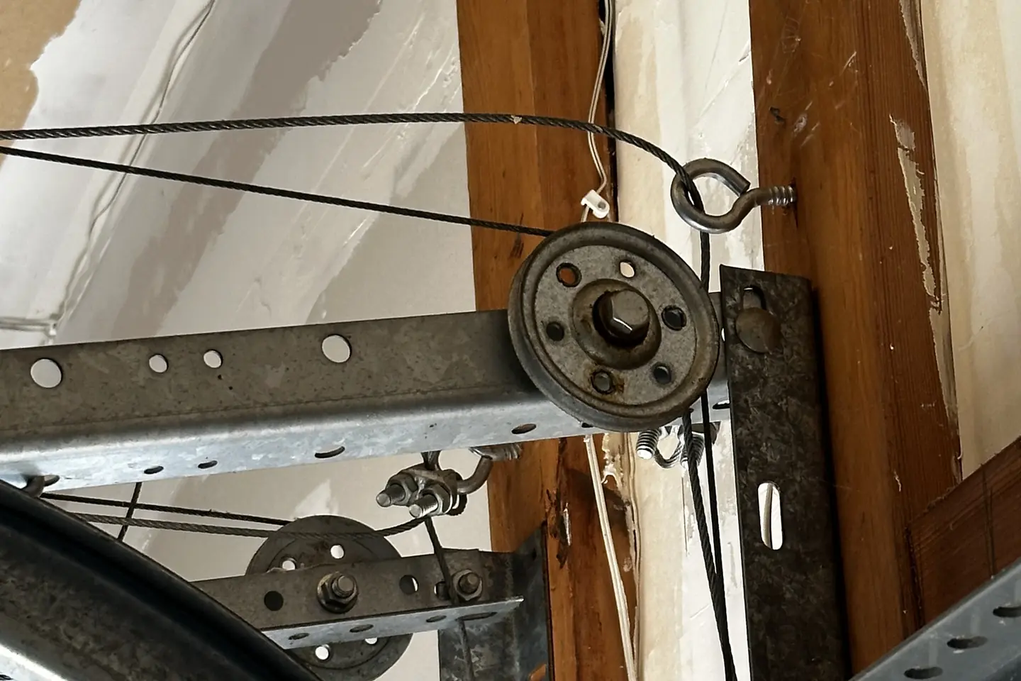 Close view of garage door track and cable hardware