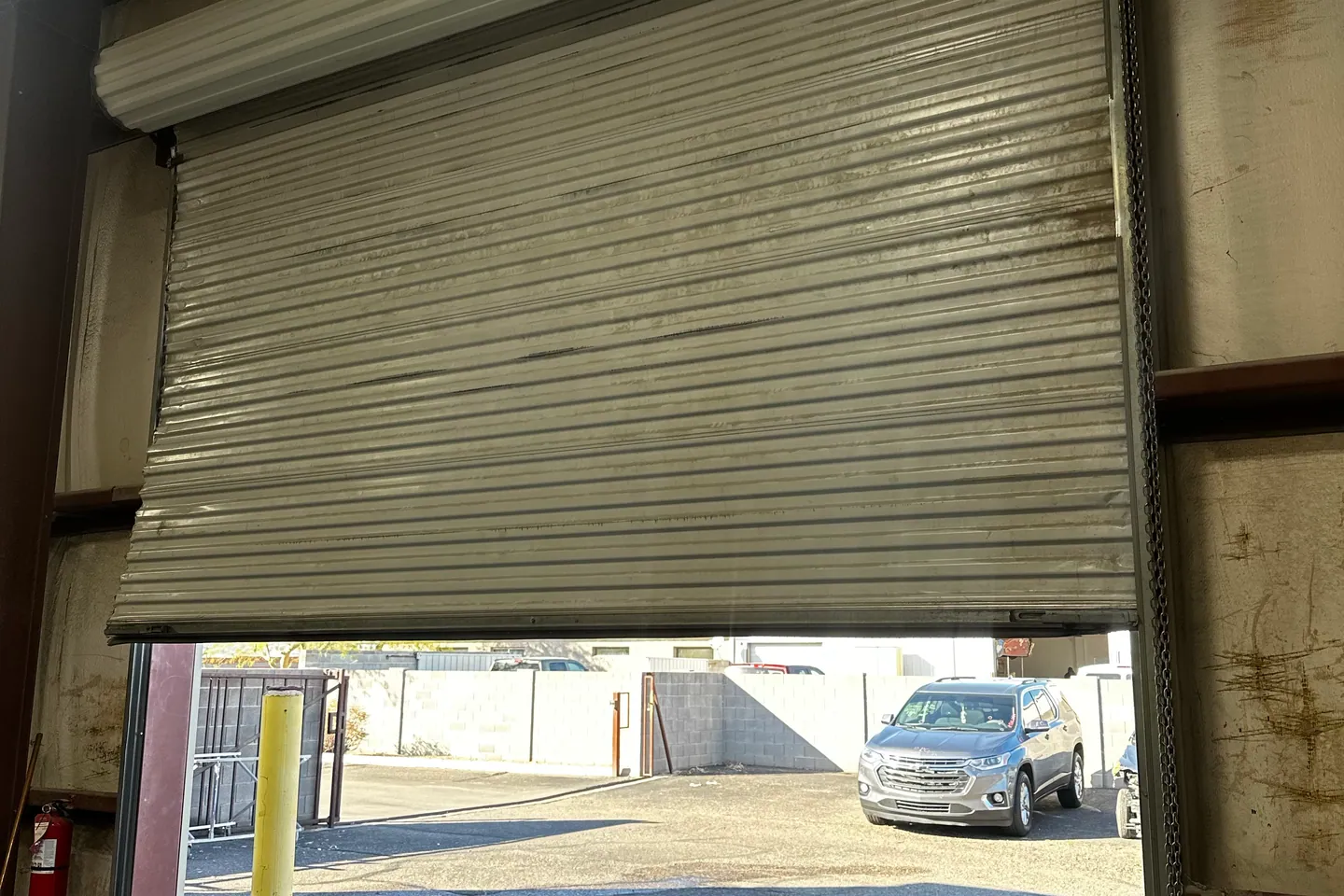Commercial roll-up door open at a service bay