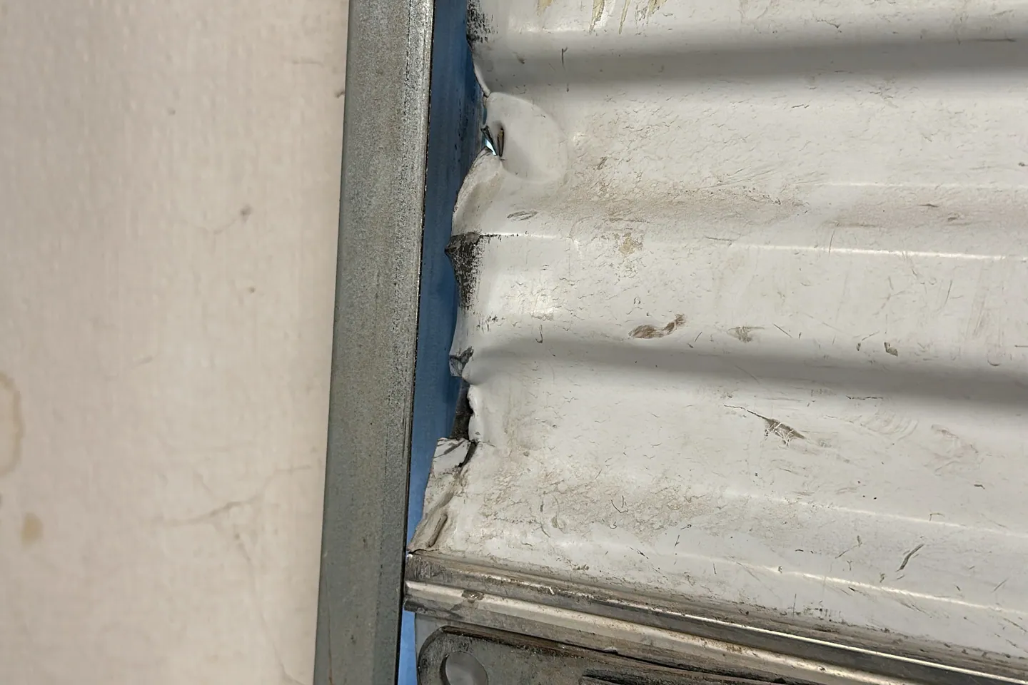 Garage door sections damaged and out of alignment